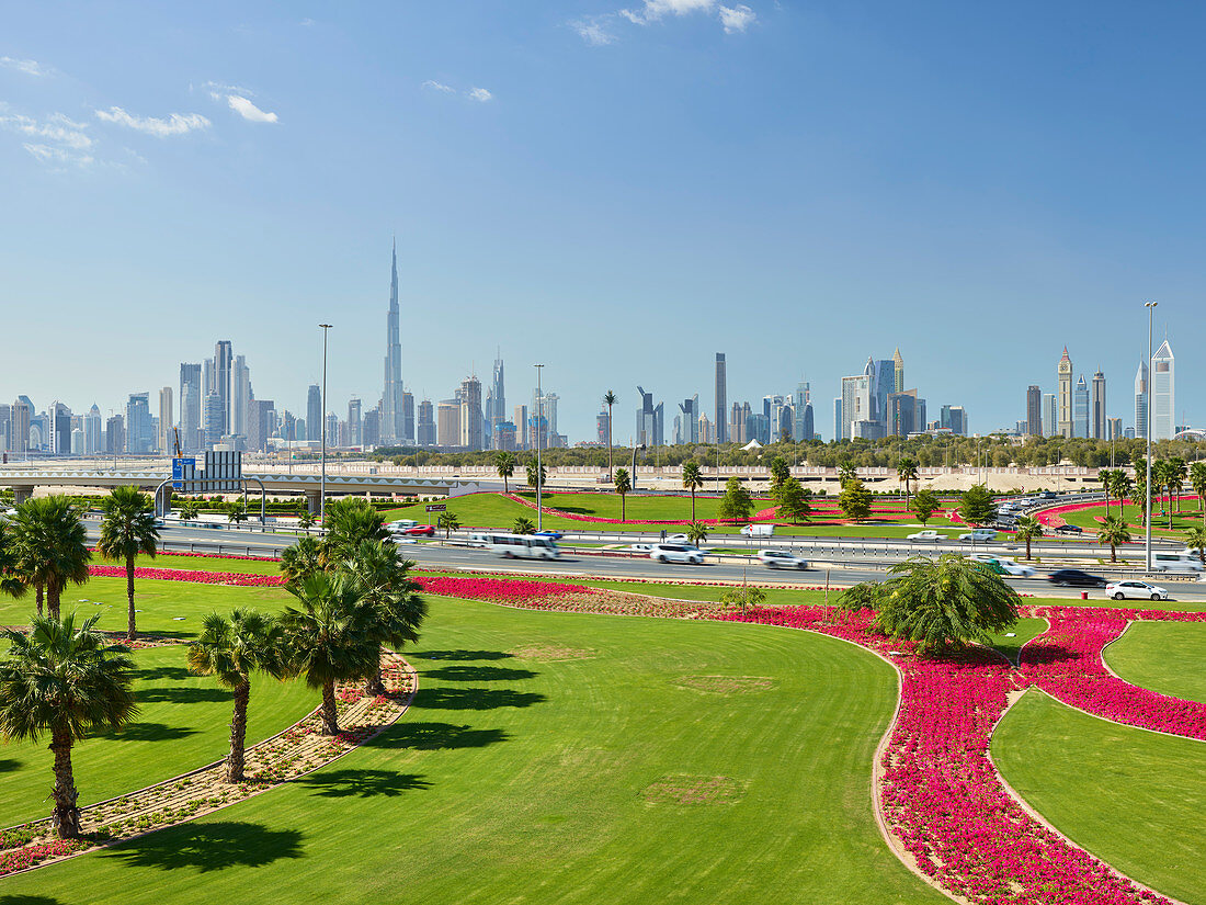 Skyline, green WIese, palm trees, flowers, Dubai, United Arab Emirates