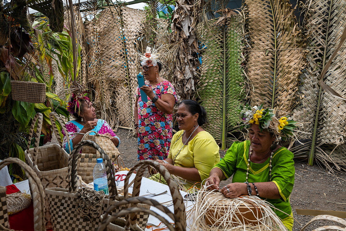 Women demonstrate traditional weaving at a cultural festival, Papeete, Tahiti, Windward Islands, French Polynesia, South Pacific