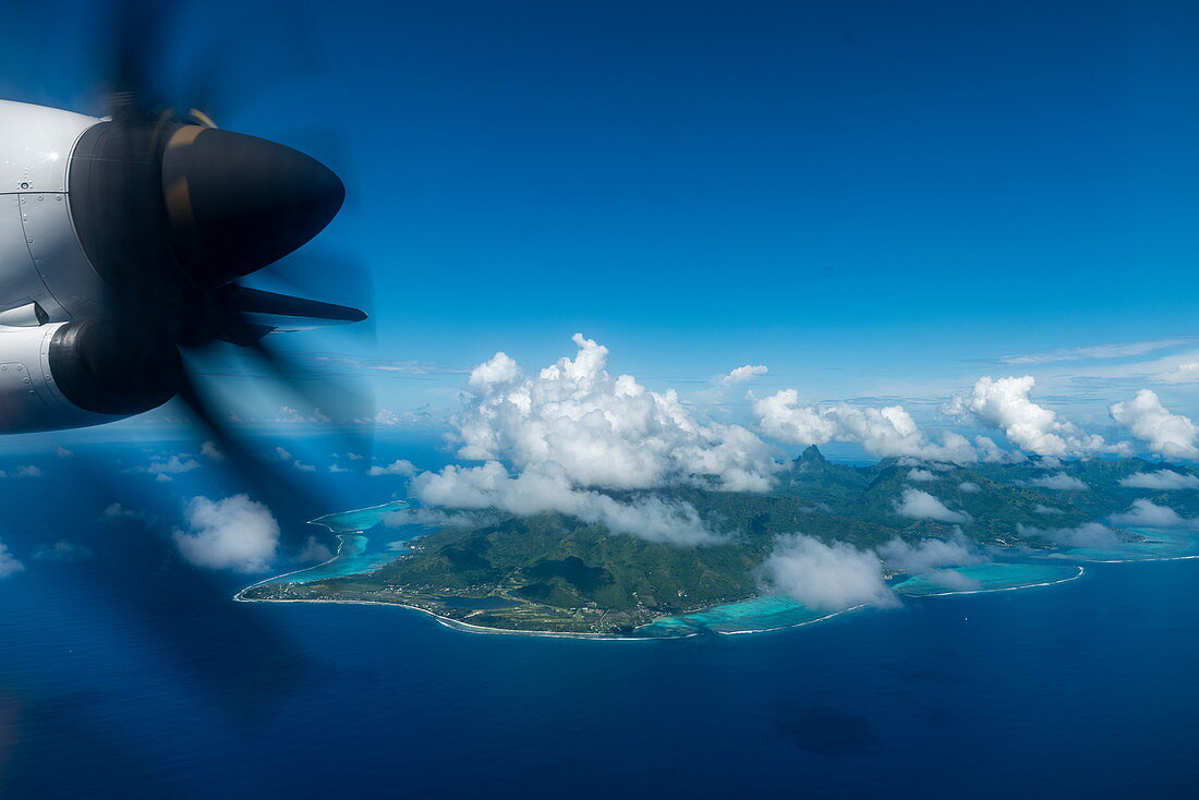 Aerial view with engine of Air Tahiti ATR 72-600 airplane and Moorea Island behind, Moorea, Windward Islands, French Polynesia, South Pacific