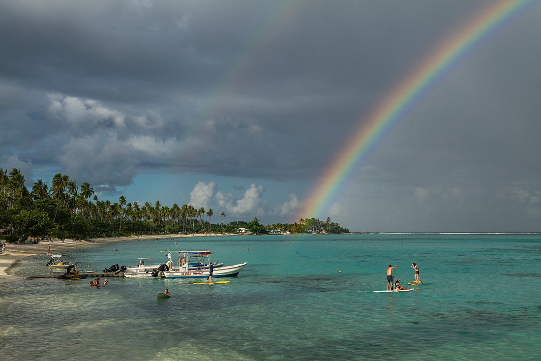 Water sports activities at Sofitel Ia Ora Beach Resort with rainbow over Moorea Lagoon, Moorea, Windward Islands, French Polynesia, South Pacific
