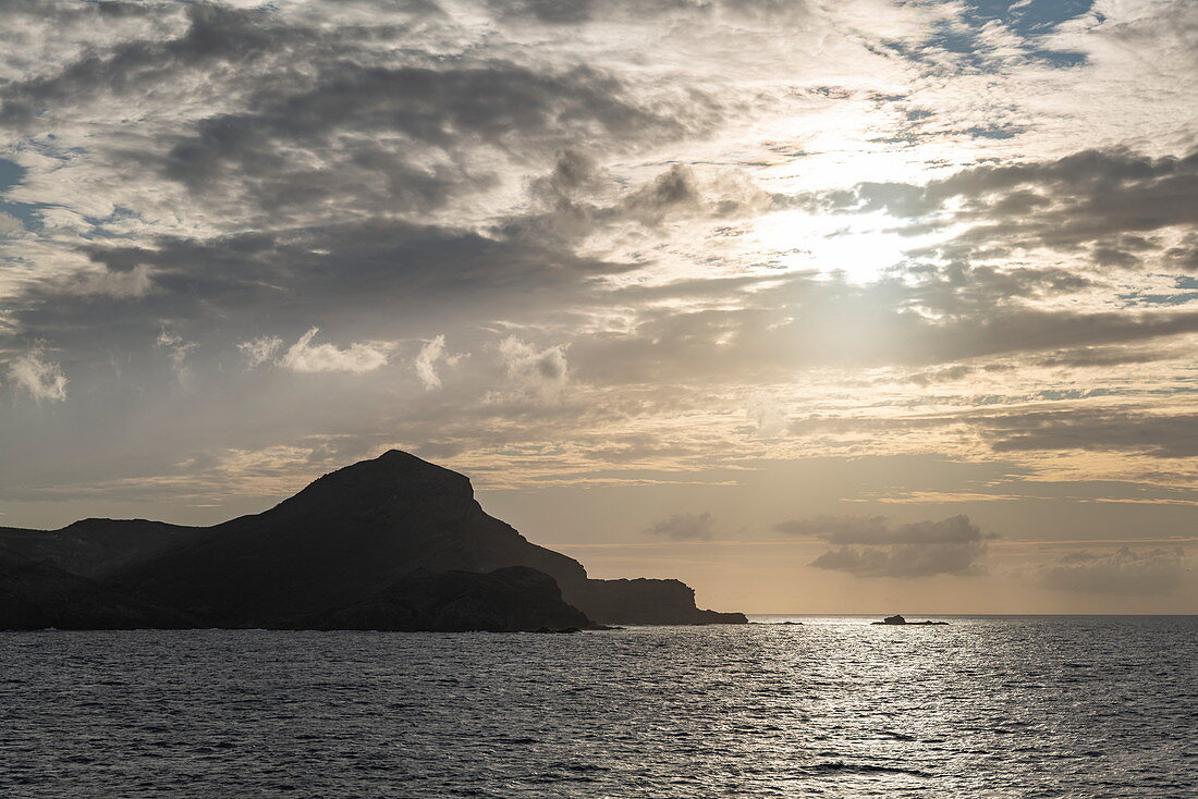 Clouds and coastline at sunset, near Ua Pou, Marquesas Islands, French Polynesia, South Pacific