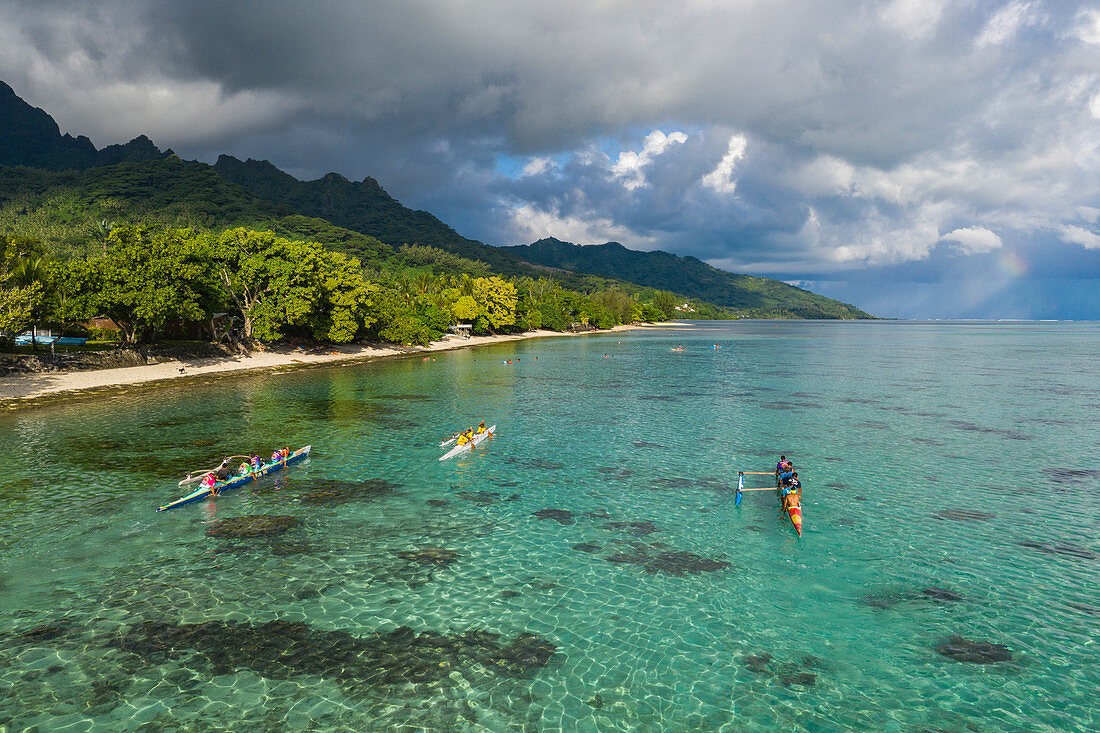 Aerial view of outrigger racing canoes in the Moorea Lagoon, Avamotu, Moorea, Windward Islands, French Polynesia, South Pacific