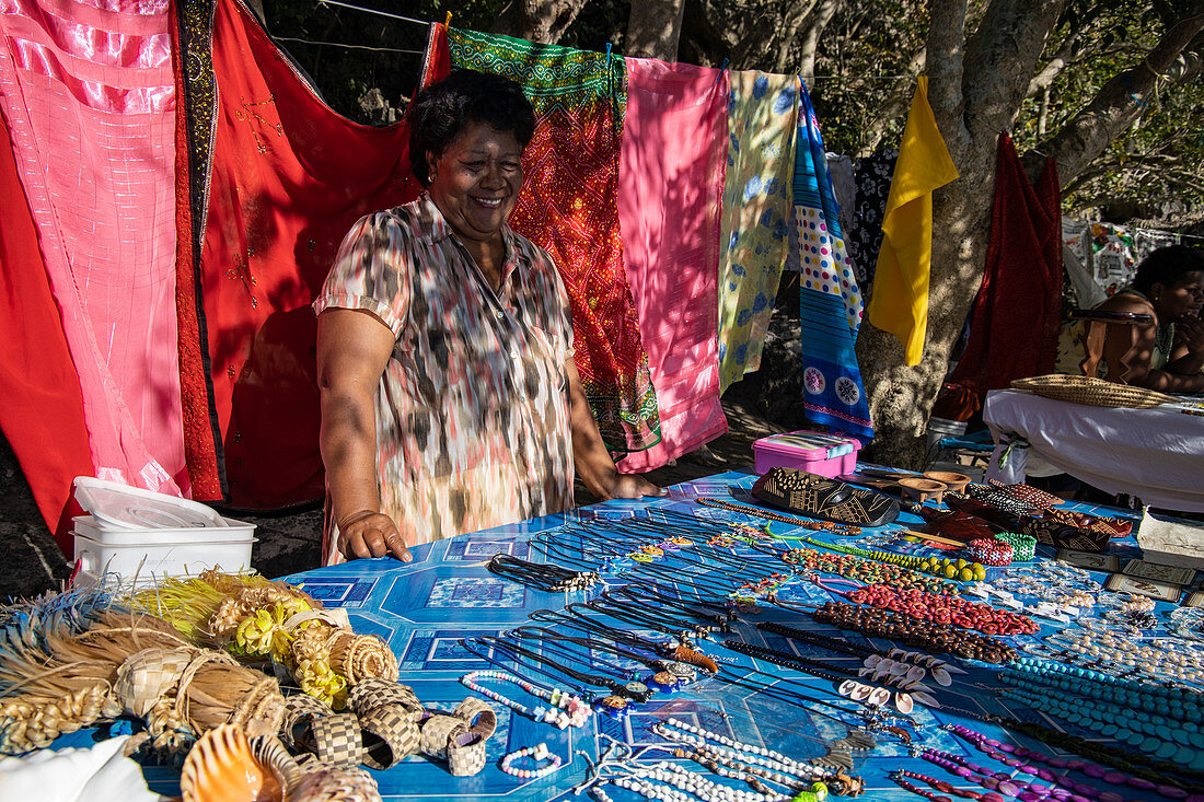 Smiling woman with handicrafts and pareo towels for sale at a souvenir stand on the beach, Sawa-i-Lau Island, Yasawa Group, Fiji Islands, South Pacific