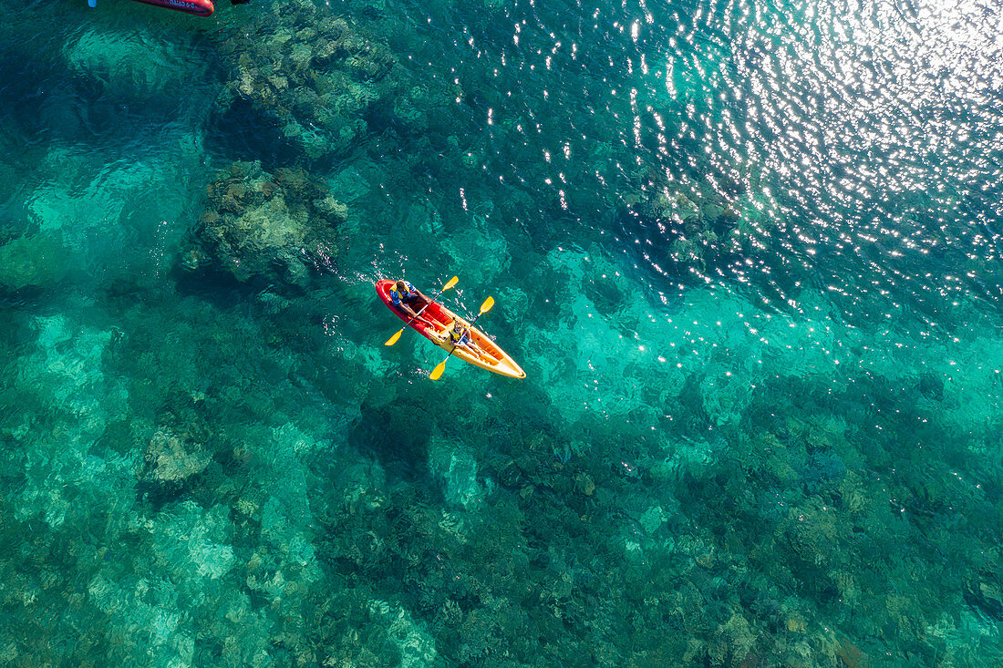 Aerial view of passengers of the cruise ship MV Reef Endeavor (Captain Cook Cruises Fiji) enjoying water sports along a coral reef, Yaqeta, Yangetta Island, Yasawa Group, Fiji Islands, South Pacific