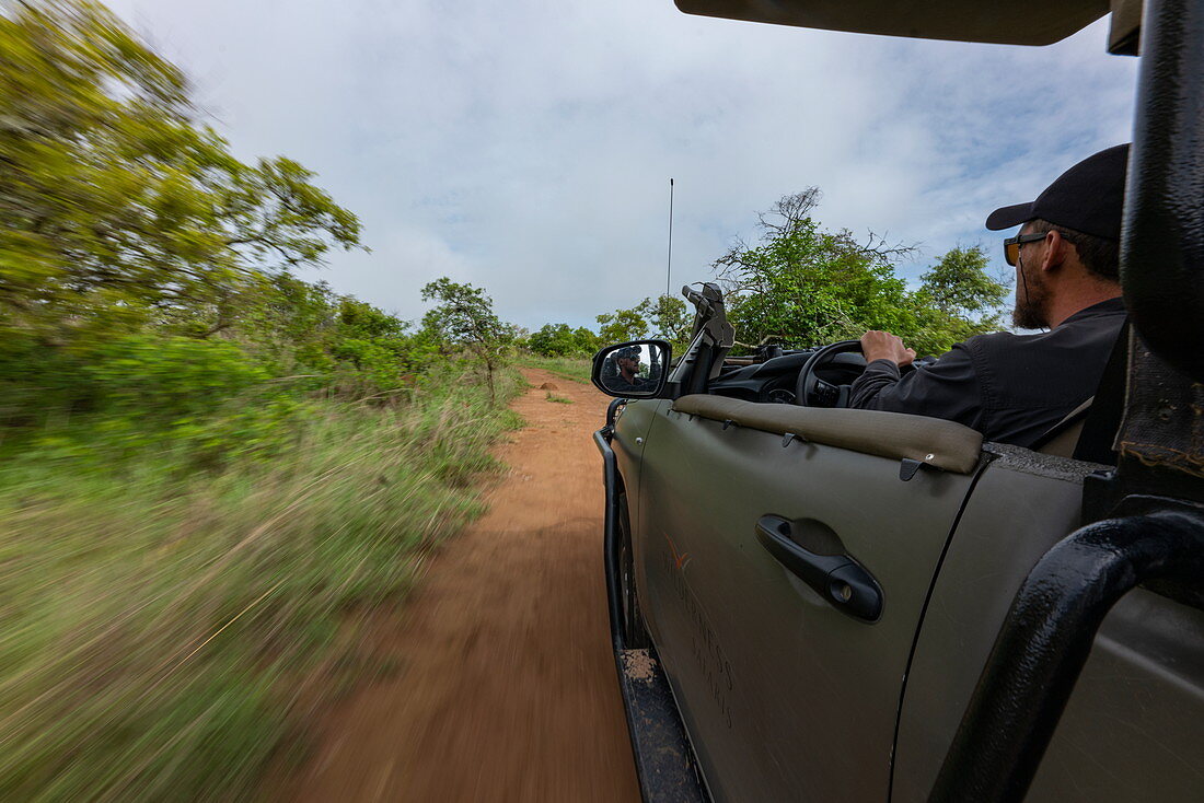 Side view of a safari vehicle operated by luxury resort tented Magashi Camp (Wilderness Safaris), Akagera National Park, Eastern Province, Rwanda, Africa