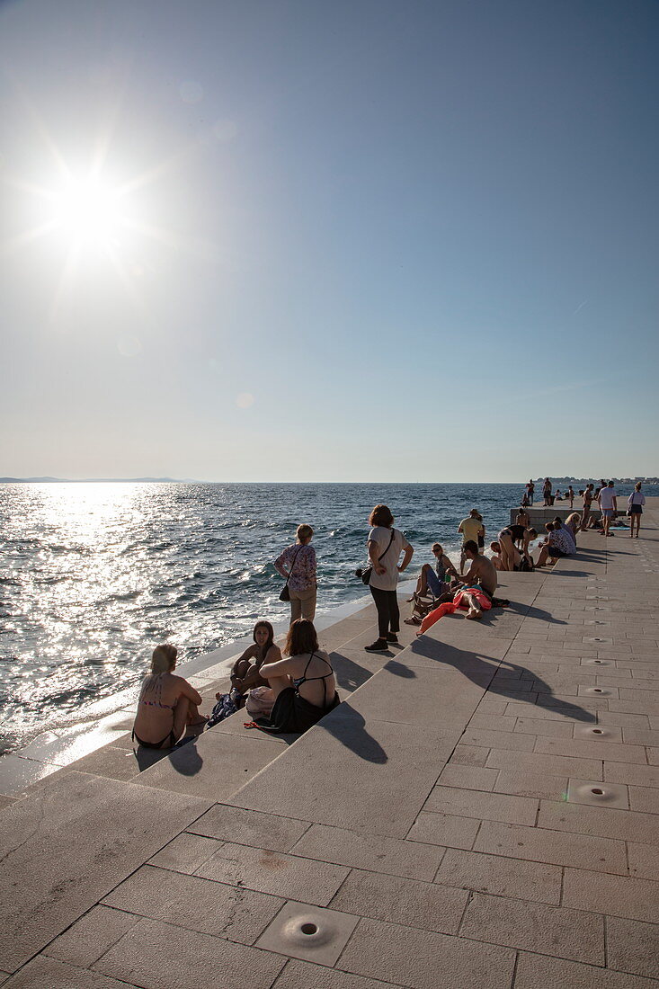 People relax on the beach promenade and listen to the sea organ, Zadar, Zadar, Croatia, Europe