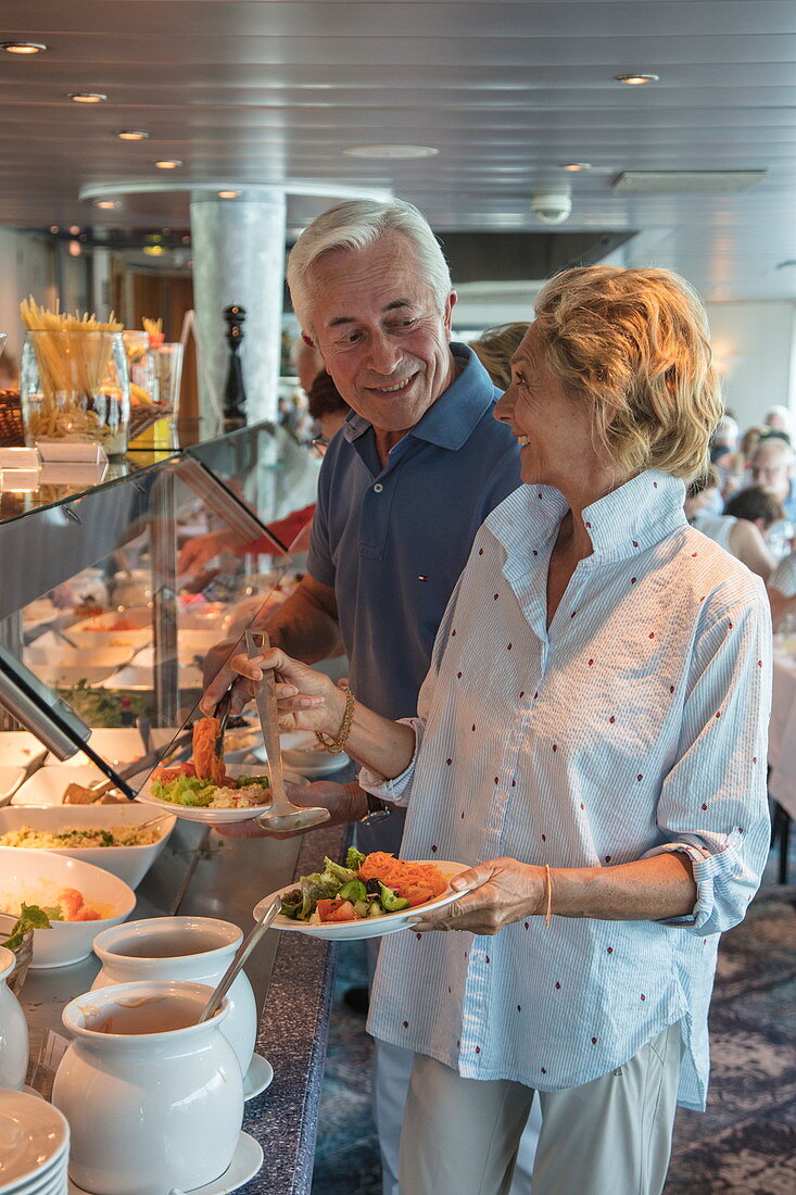 Couple at the lunch buffet in the Panorama Restaurant on board the river cruise ship during a cruise on the Rhine, Koblenz, Rhineland-Palatinate, Germany, Europe