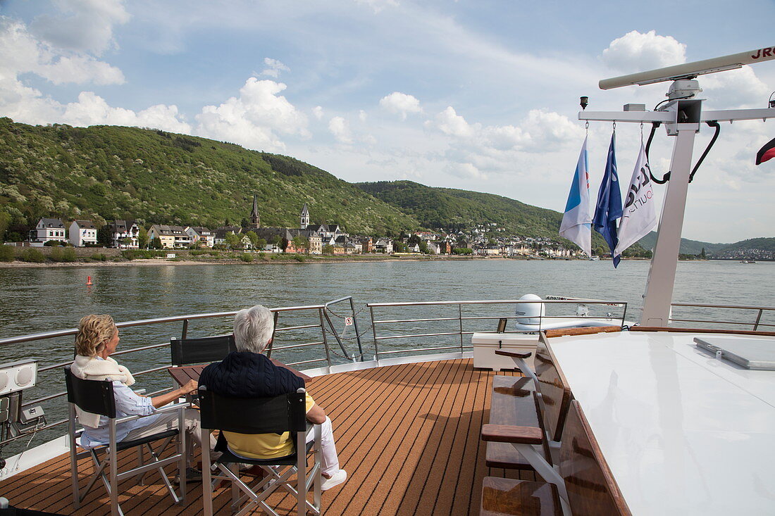 Couple on sundeck of river cruise ship during a cruise on the Rhine, near Boppard, Rhineland-Palatinate, Germany, Europe