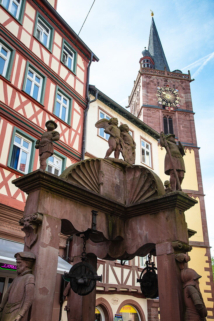 Angel fountain in front of half-timbered houses in the old town with tower of the collegiate church, Wertheim, Spessart-Mainland, Franconia, Baden-Wuerttemberg, Germany, Europe