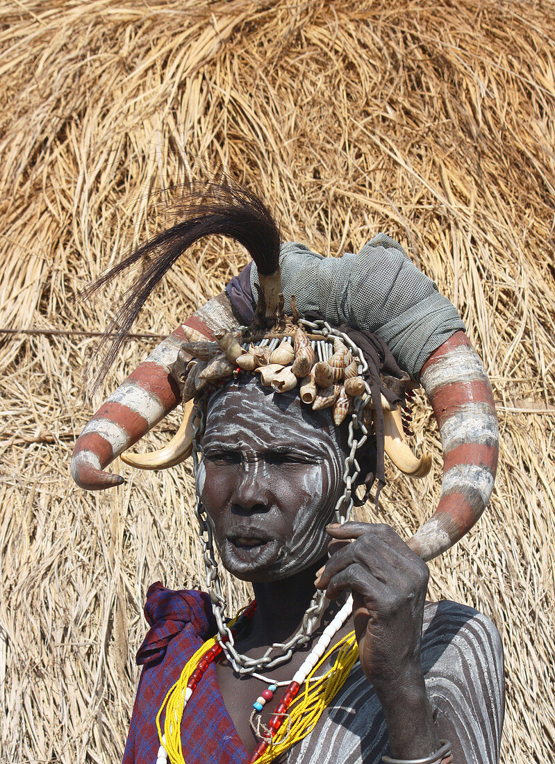 Ethiopia; Southern Nations Region; southern Ethiopian highlands; Mago National Park; lower Omo River; elderly Mursi woman with headdress and face and body painting;