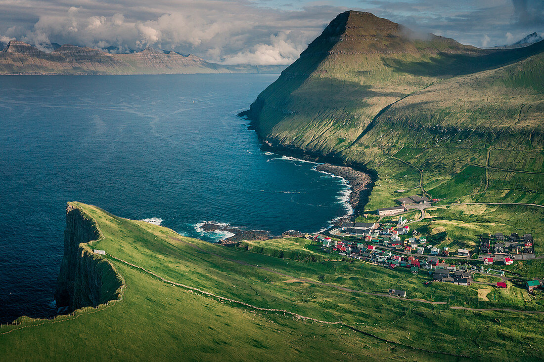 Village of Gjogv on Eysteroy with gorge, sea and mountains, Faroe Islands