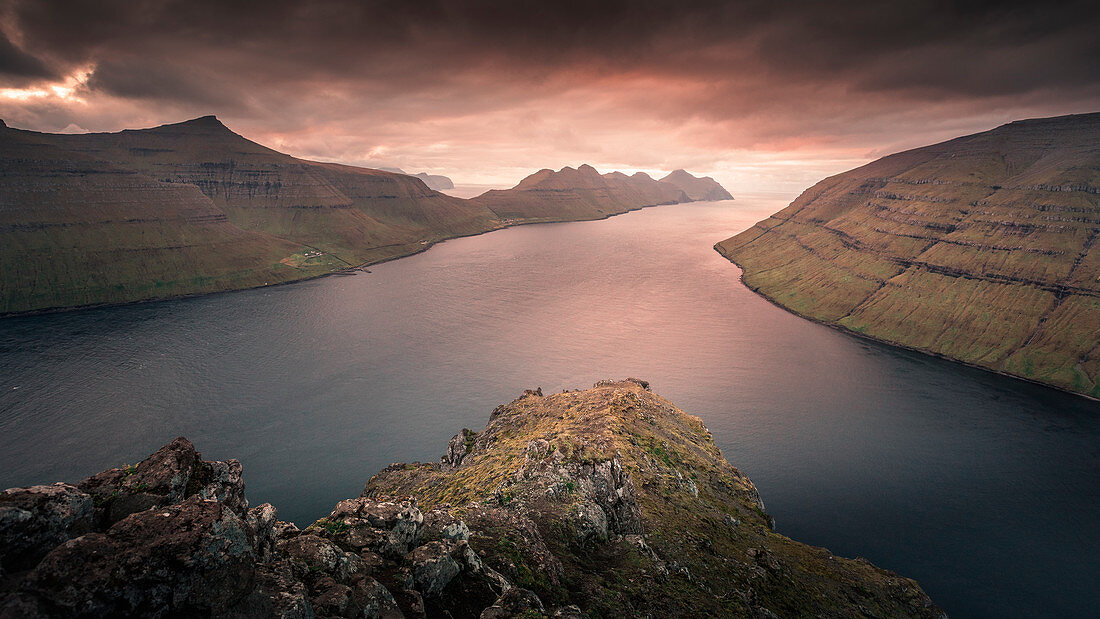 Panorama at the Klakkur viewpoint near Klaksvik on the island of Bordaoy with a view of Klasoy and Kunoy in sunset, Faroe Islands