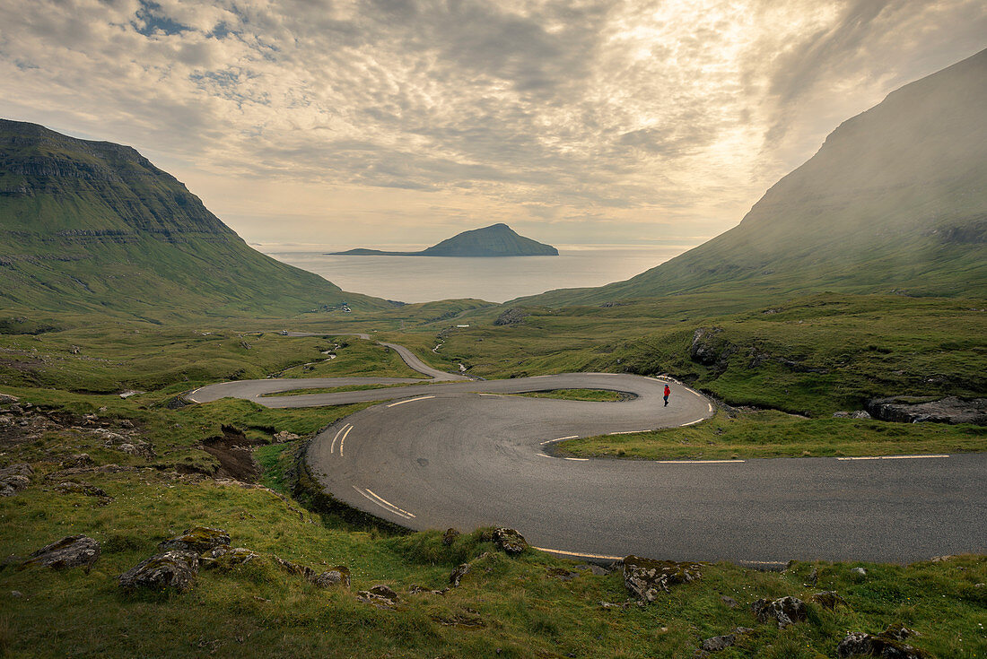 Man on the winding road to Norðradalur on Streymoy, Faroe Islands