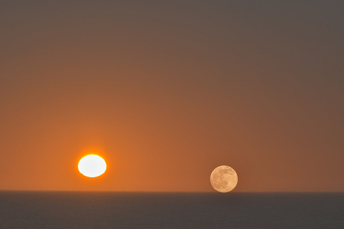 Sun and moon shine side by side over the sea, Grimsholmen, Hallandslän, Sweden