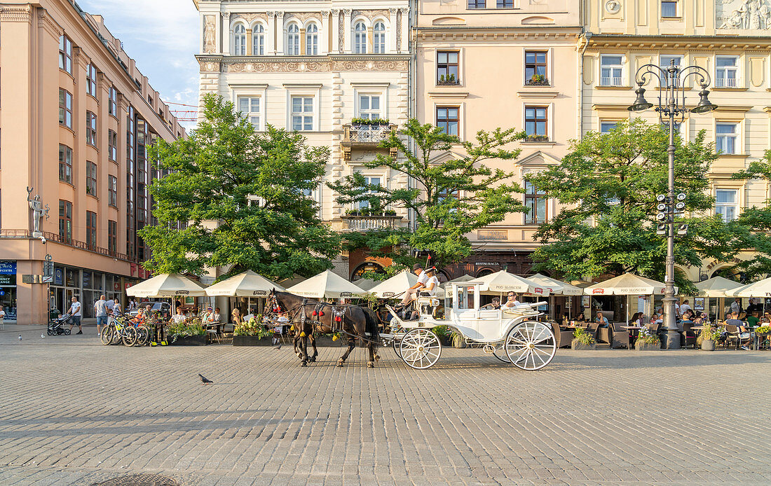 Horse and carrriage taxi in The Old town Square, UNESCO World Heritage Site, Krakow, Poland, Europe