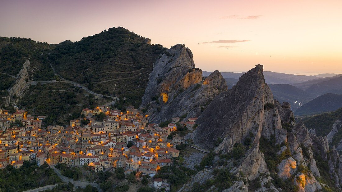 aerial view taken by drone of the village of Castelmezzano during a golden hours in summer time, with the Lucanian Dolomites in the background, municipality of Castelmezzano, Potenza province, Basilicata district, southern Italy, Europe