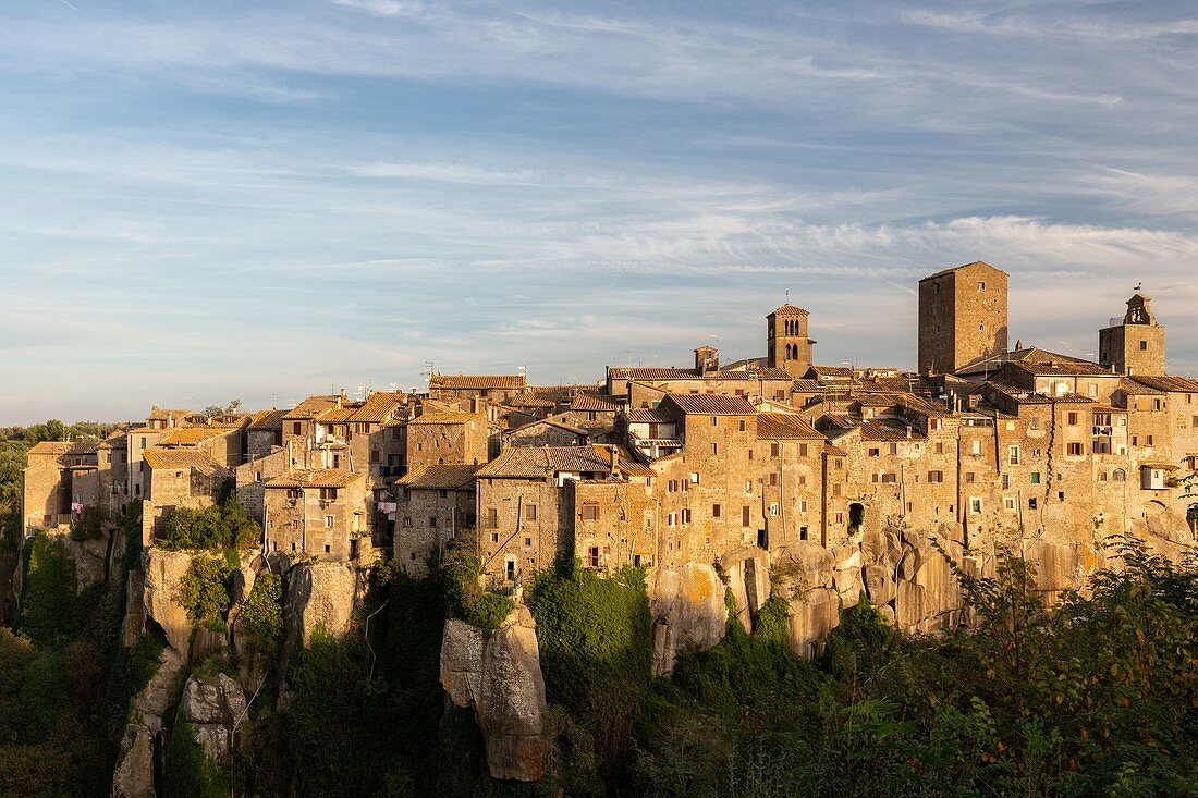 The village of Vitorchiano stands on a big rock over a canyon photographed during the sunset. Europe, Italy, Lazio, Province of Viterbo, Vitorchiano