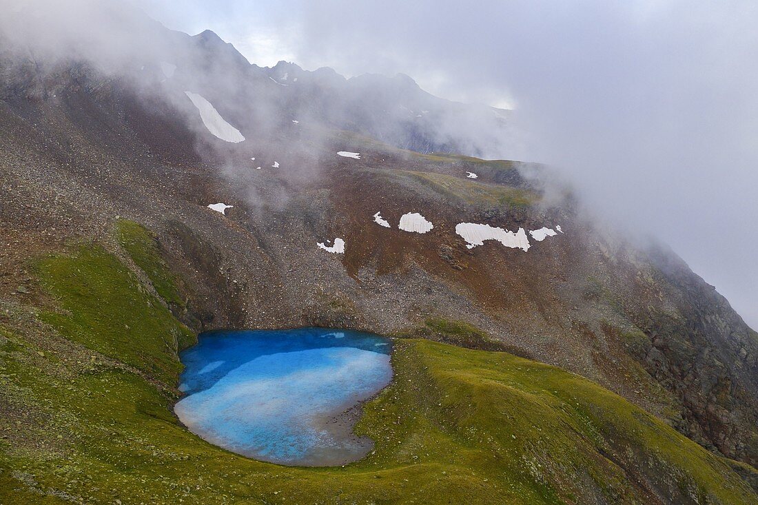 Aerial view of Vago lake during misty summer morning, Livigno, Lombardy, Italy, Southern Europe