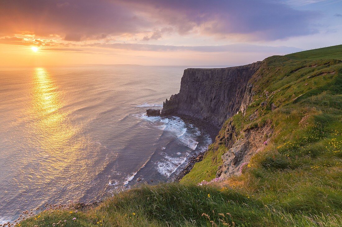 View of a sunset at the Cliffs of Moher. County Clare, Munster province, Ireland, Europe.