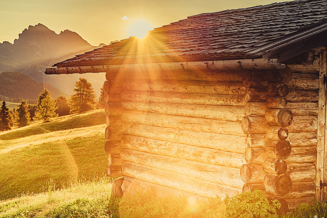 Hut at sunrise on the Seiser Alm in South Tyrol, Italy, Europe;