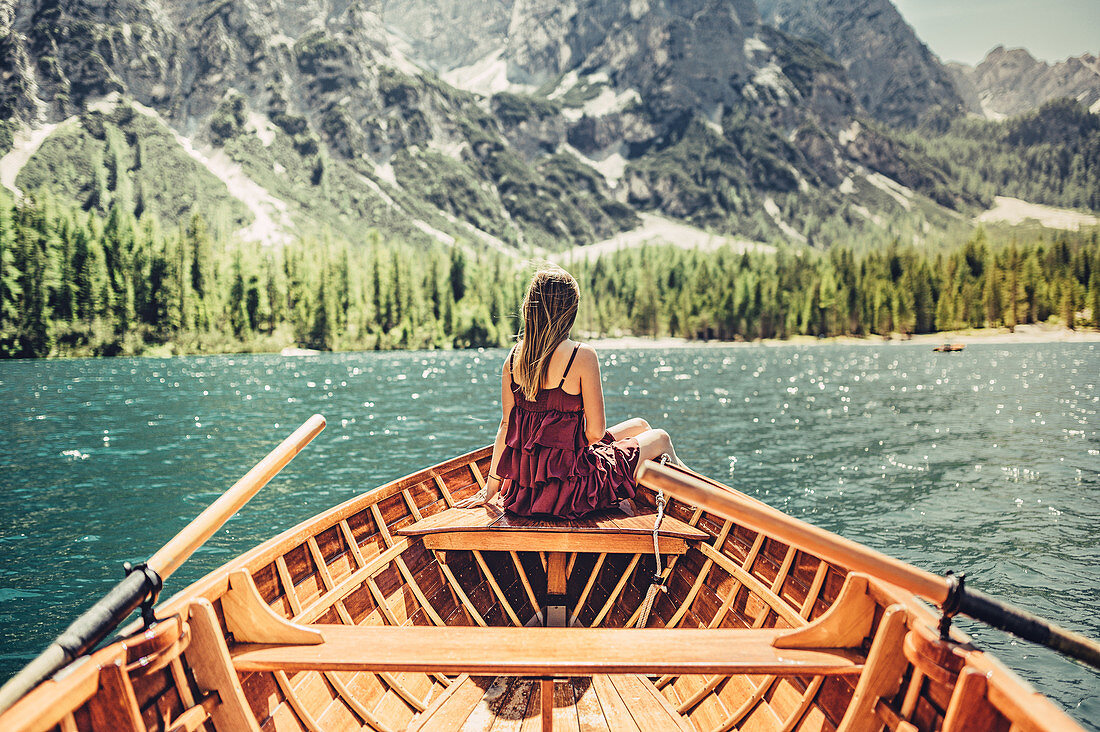 Woman on a boat trip on Lake Braies amid the Dolomites in South Tyrol, Italy, Europe