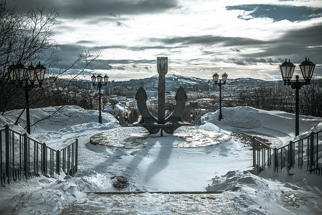 View of the anchor and the city of Murmansk with mountains in the background, Russia