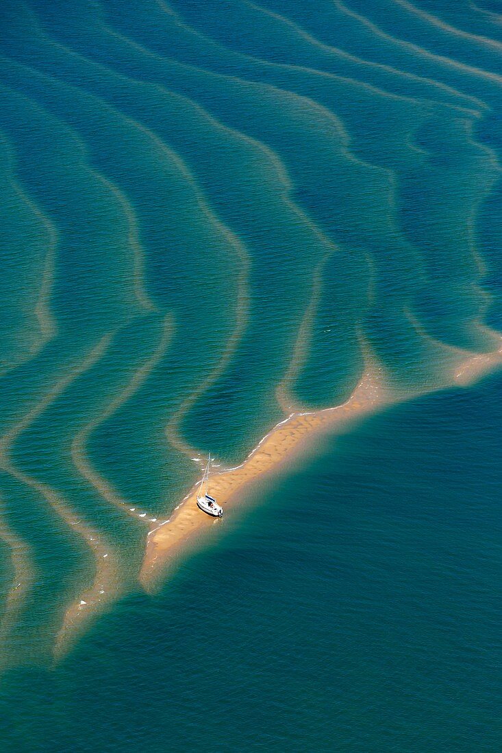 France, Gironde, Bassin d'Arcachon at low tide seen from the sky, pleasure boat on a sandbar (aerial view)