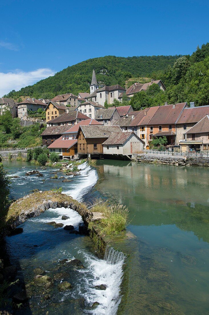 France, Doubs, Loue valley, one of many thresholds over the river reflect the village of Lods one of the most beautiful villages in France