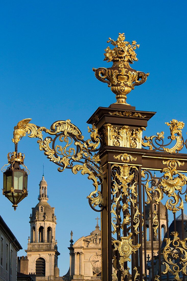 France, Meurthe et Moselle, Nancy, Stanislas square (former royal square) built by Stanislas Lescynski, king of Poland and last duke of Lorraine in the 18th century, listed as World Heritage by UNESCO, metal gate and railings covered with gold leaves by Jean Lamour, Notre Dame de l'Annonciation cathedral in the background