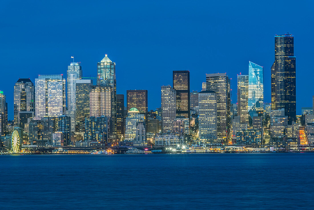 Seattle skyline, from Puget Sound, downtown buildings  at night.