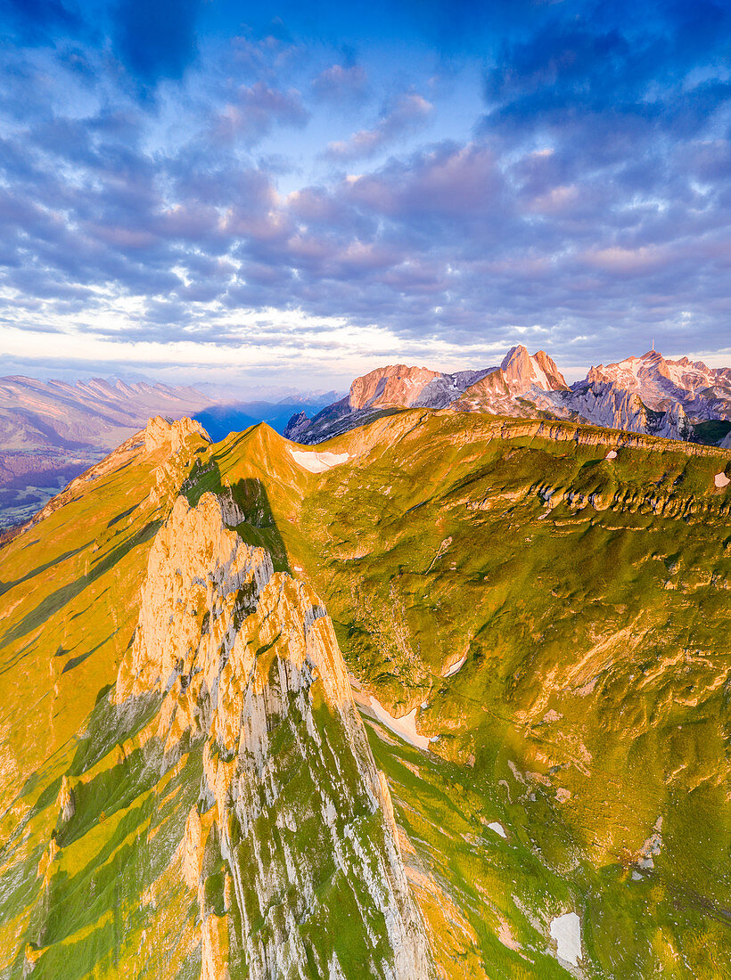 Clouds at dawn over the majestic peaks of Santis and Saxer Lucke, aerial view, Appenzell Canton, Alpstein Range, Switzerland, Europe