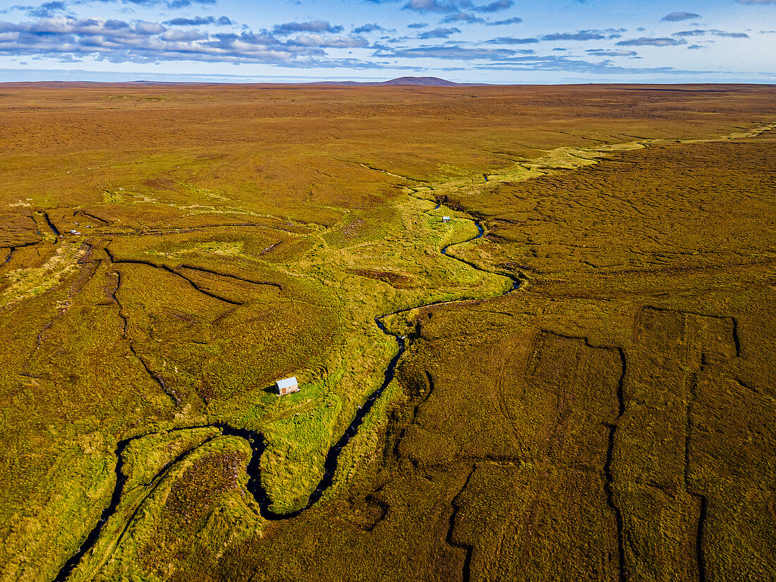 Aerial of a little hut in the Moorland on the Isle of Lewis, Outer Hebrides, Scotland, United Kingdom, Europe