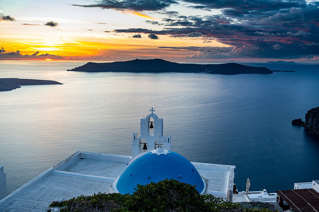 Sunset over the volcanic islands of Santorini and Anastasi Orthodox Church at sunset, Fira, Santorini, Cyclades, Greek Islands, Greece, Europe