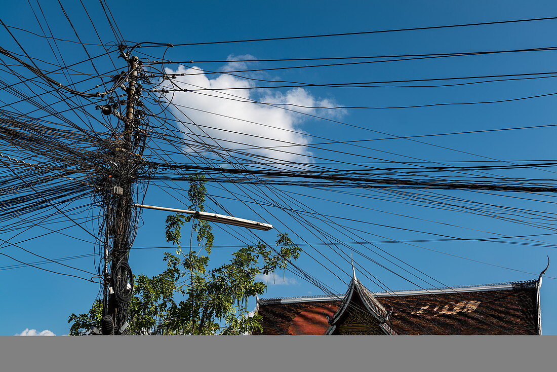 A chaotic but functional cluster of telephone and power lines, Luang Prabang, Luang Prabang Province, Laos, Asia