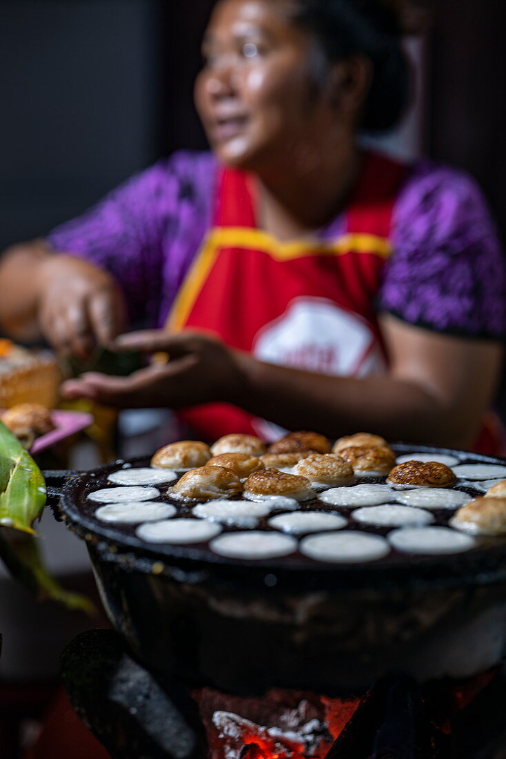 Delicious coconut pancakes are baked over charcoal at the night market on Sisavangvong Road (main street), Luang Prabang, Luang Prabang Province, Laos, Asia
