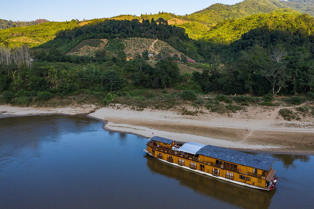 Aerial view of river cruise ship Mekong Sun moored on the sandy bank of the Mekong River, Ban Hoy Palam, Pak Tha District, Bokeo Province, Laos, Asia