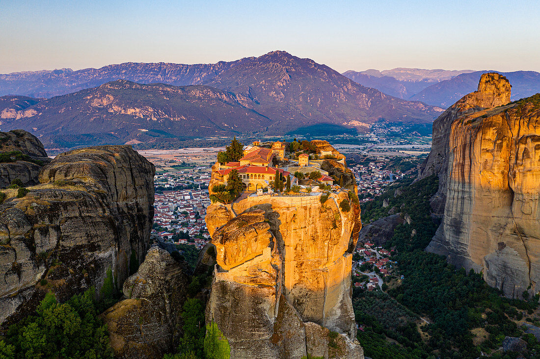 Aerial by drone of the Holy Monastery of Holy Trinity at sunrise, UNESCO World Heritage Site, Meteora Monasteries, Greece, Europe