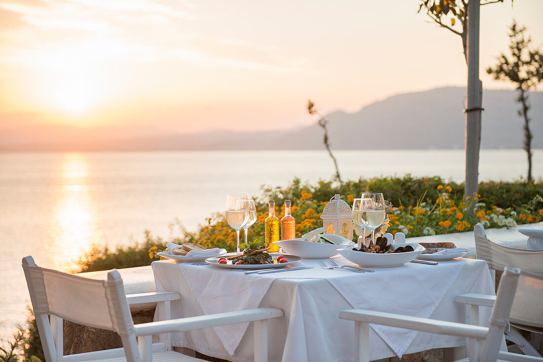 Food at a restaurant with a view over Pefkos Beach beach at sunset, Pefkos, Rhodes, Dodecanese, Greek Islands, Greece, Europe