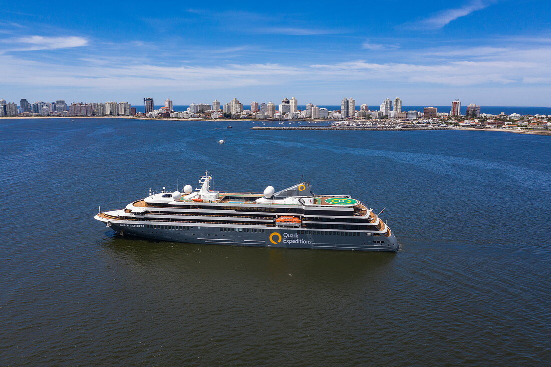 Aerial view of expedition cruise ship World Explorer (Nicko Cruises) with city skyline behind, Punta del Este, Maldonado Department, Uruguay, South America