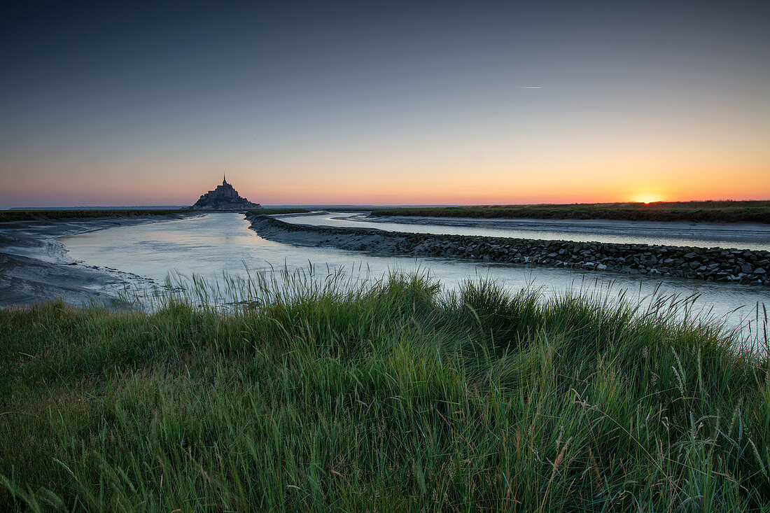 Morning view of the rocky island of Mont Saint Michel with the monastery of the same name, Normandy, France.