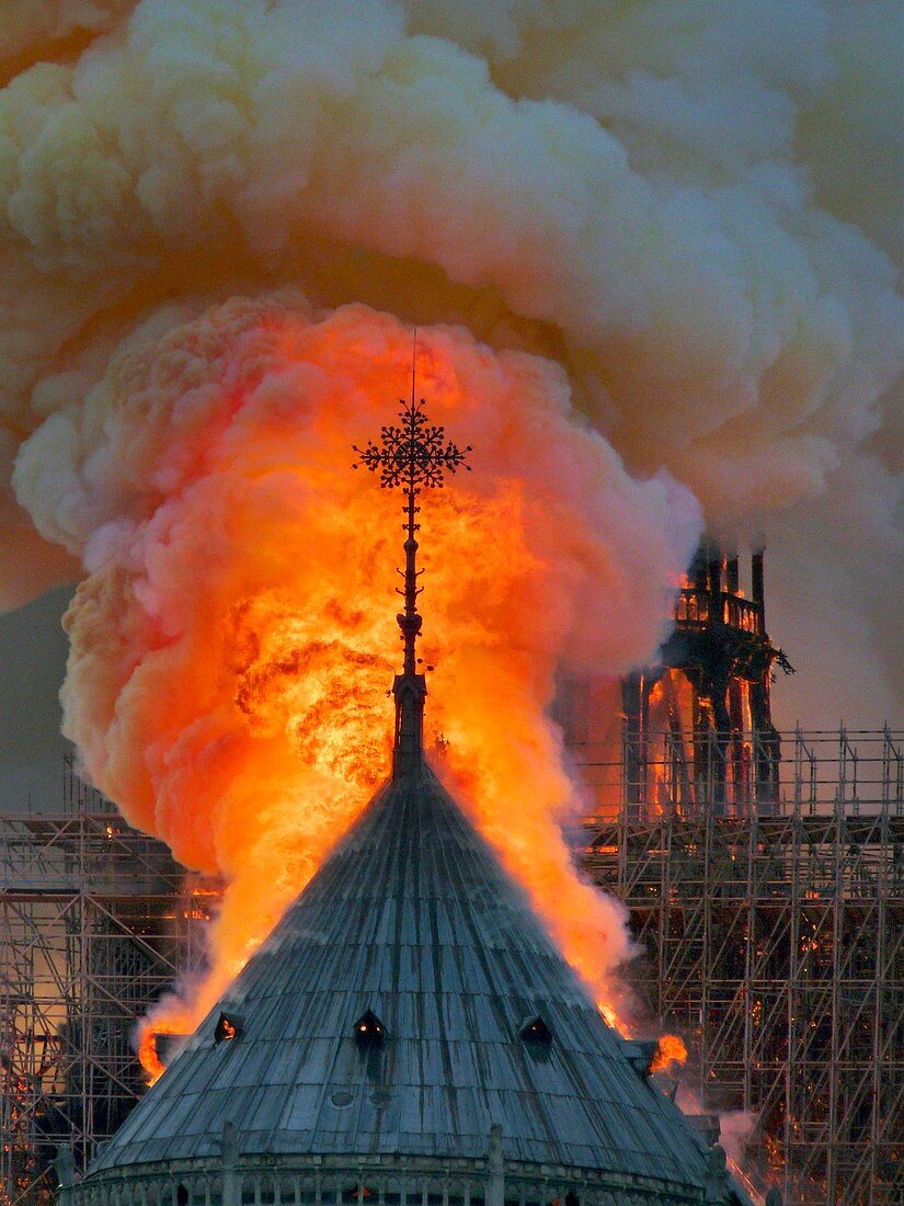 France, Paris, area listed as World Heritage by UNESCO, Notre Dame Cathedral of 14th century Gothic architecture during the fire of 15th April 2019, close up on the flames surrounding the cross