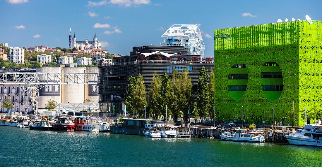 France, Rhone, Lyon, district of La Confluence in the south of the peninsula, first French quarter certified sustainable by the WWF, view of the quai Rambaud along the old docks with the Green Cube, the Ycone tower, the Sucriere and Notre Dame de Fourviere Basilica
