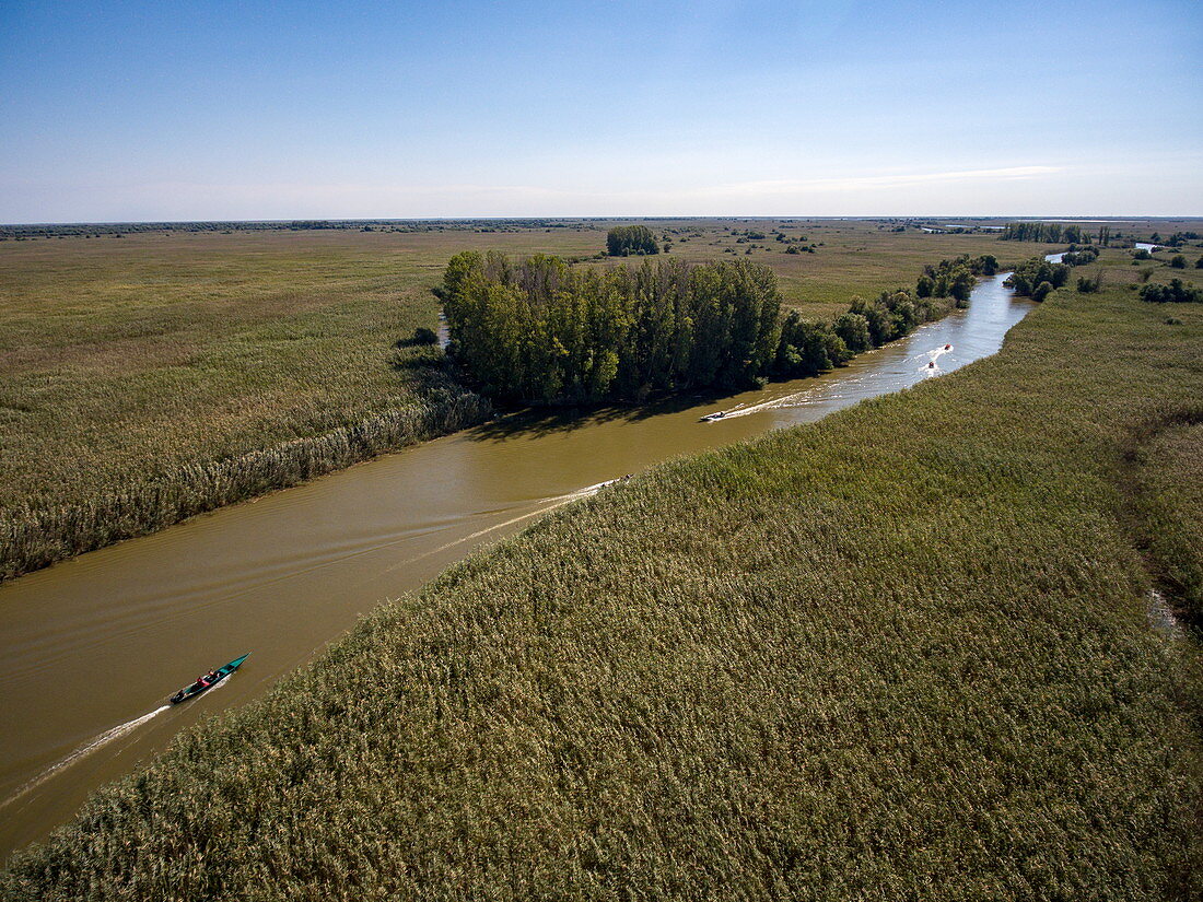 Aerial view of motorboat excursion to wetlands in the Volga Delta, near Karalat, Ostrakhan District, Russia, Europe