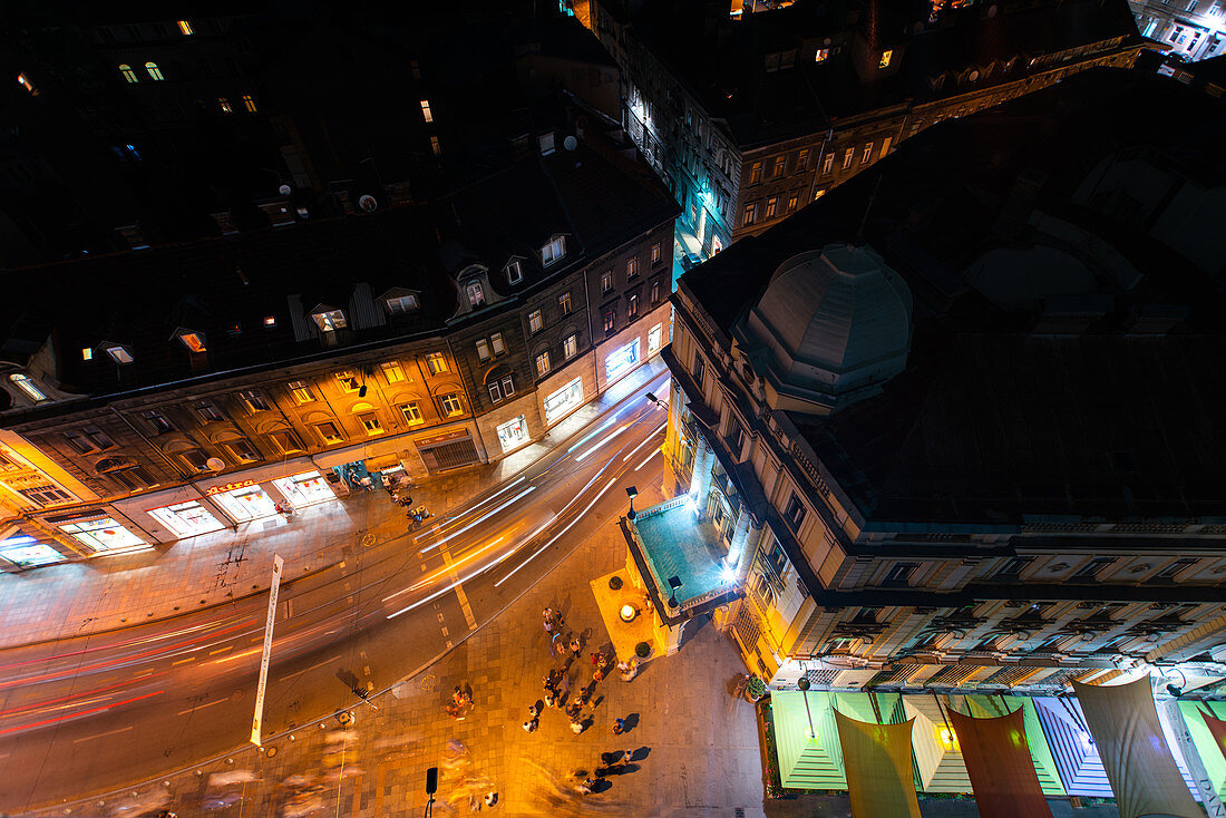 Overhead view of pedestrians and traffic on street at night