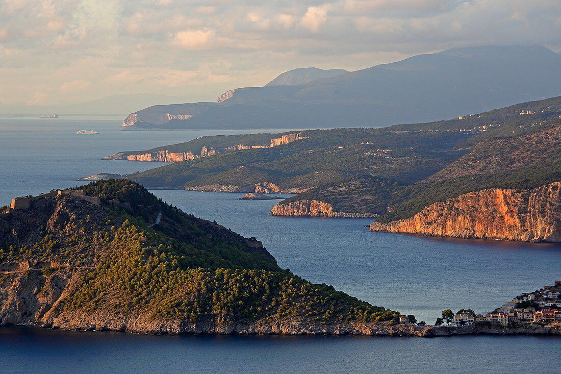 View over the rugged west coast to the north, in the foreground the town of Assos with its castle, Kefalonia Island, Ionian Islands, Greece
