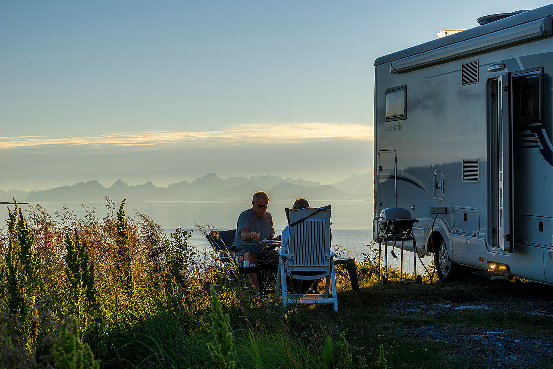 View of the Lofoten Islands with people in front of the motorhome from Hamarøy, Norway