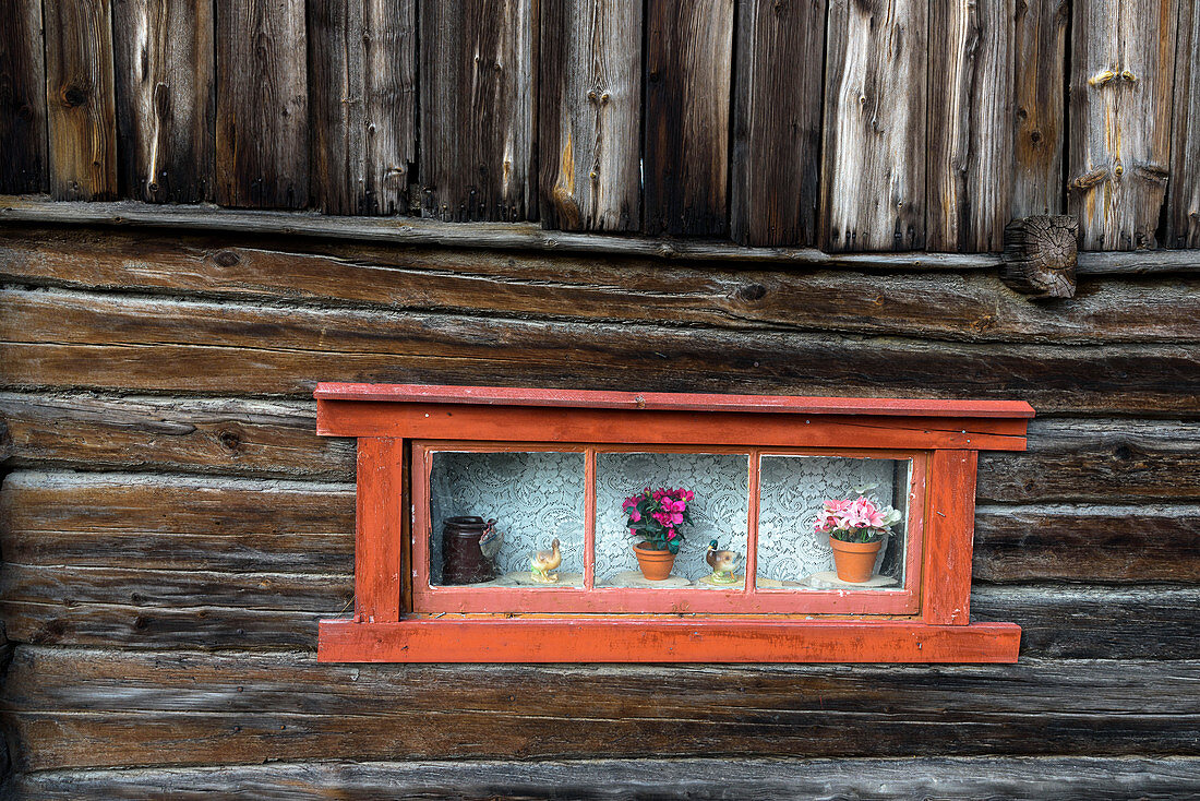 Old window with flowers, Røros mining town: Bergstaden (old town), Roros, Norway