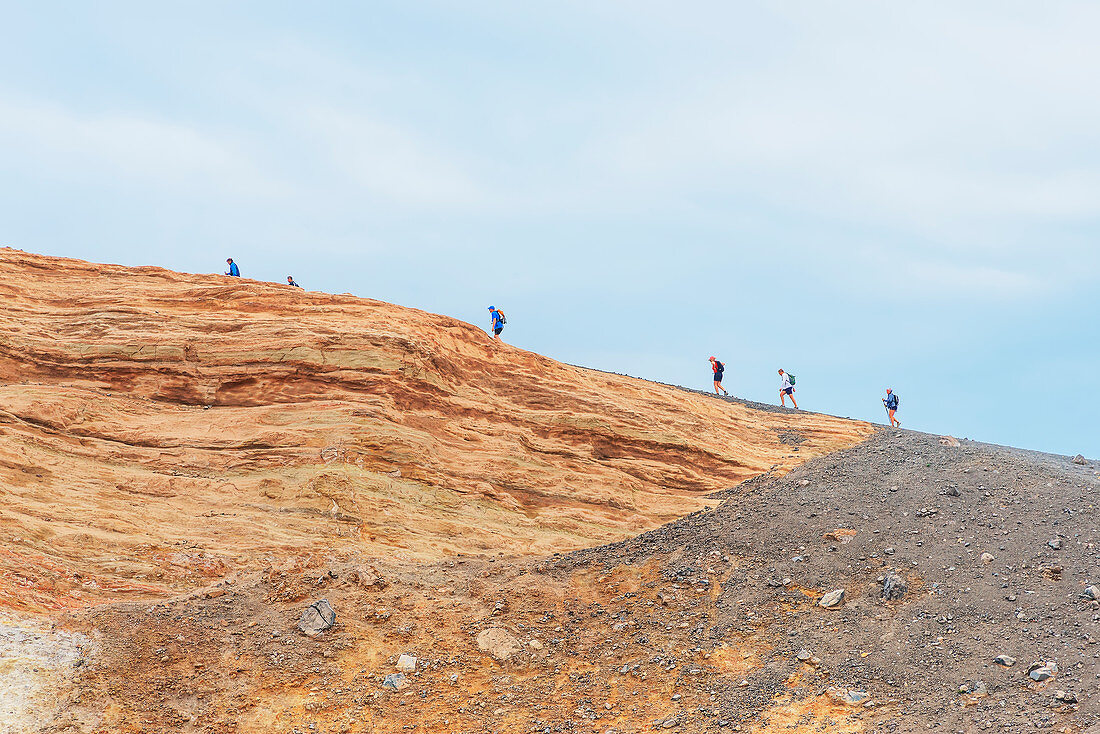 People walking around Gran Crater rim, Vulcano Island, Aeolian Islands, Sicily, Italy