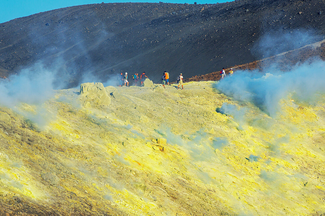 People walking on Gran Cratere rim, Vulcano Island, Aeolian Islands, Sicily, Italy