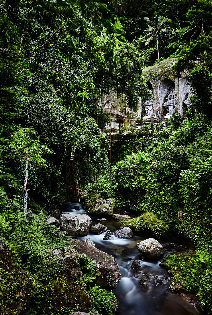 A river flows peacefully through Hindu temple Gunung Kawi in Gianyar, Bali, Indonesia.